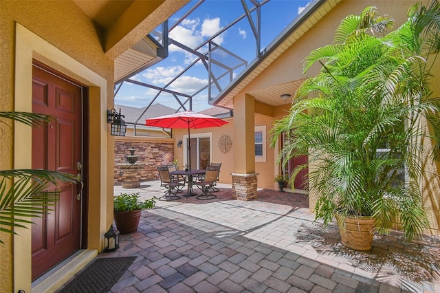 217 Sorrento Rd, Poinciana, FL 34759 - view of patio with glass enclosure and outdoor dining area
