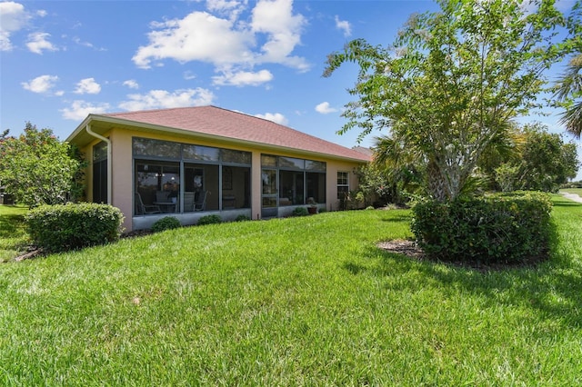 217 Sorrento Rd, Poinciana, FL 34759 - back of house with a lawn and stucco siding