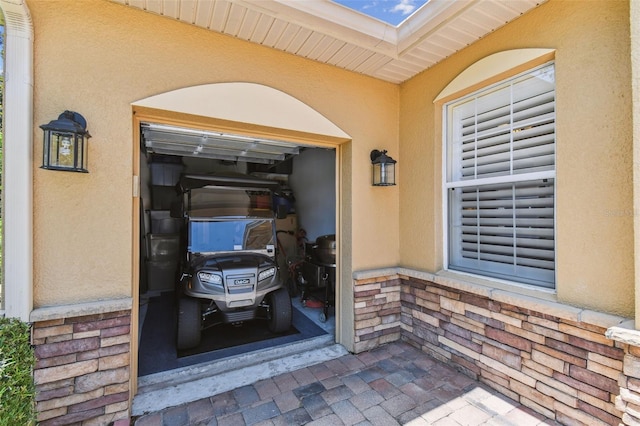 217 Sorrento Rd, Poinciana, FL 34759 - doorway to property featuring stucco siding and a garage