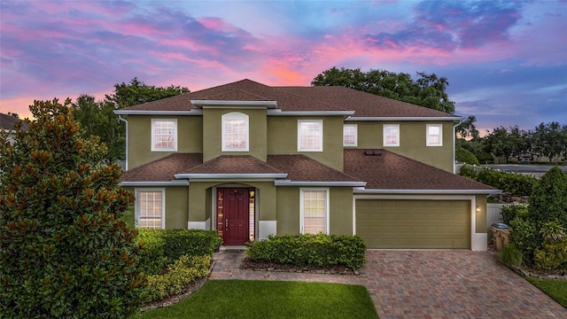 12353 Hammock Hill Dr, Clermont, FL 34711 - view of front of home with stucco siding, a shingled roof, decorative driveway, and an attached garage