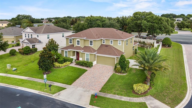 12353 Hammock Hill Dr, Clermont, FL 34711 - view of front of home featuring driveway, stucco siding, a shingled roof, a front yard, and a garage