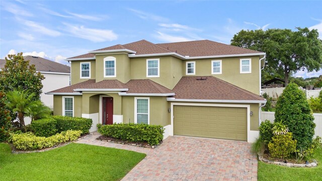 12353 Hammock Hill Dr, Clermont, FL 34711 - view of front facade with decorative driveway, stucco siding, and a shingled roof