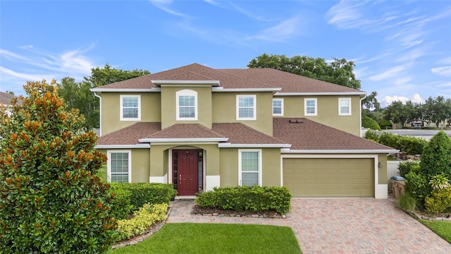 12353 Hammock Hill Dr, Clermont, FL 34711 - traditional-style house with stucco siding, decorative driveway, and roof with shingles