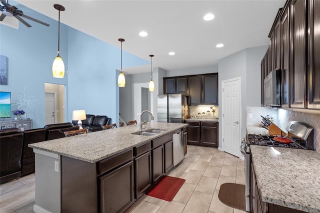 12353 Hammock Hill Dr, Clermont, FL 34711 - kitchen with appliances with stainless steel finishes, dark brown cabinetry, backsplash, a ceiling fan, and light stone counters