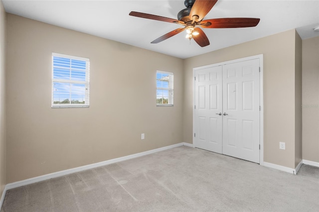 12353 Hammock Hill Dr, Clermont, FL 34711 - unfurnished bedroom with light carpet, a closet, and a ceiling fan