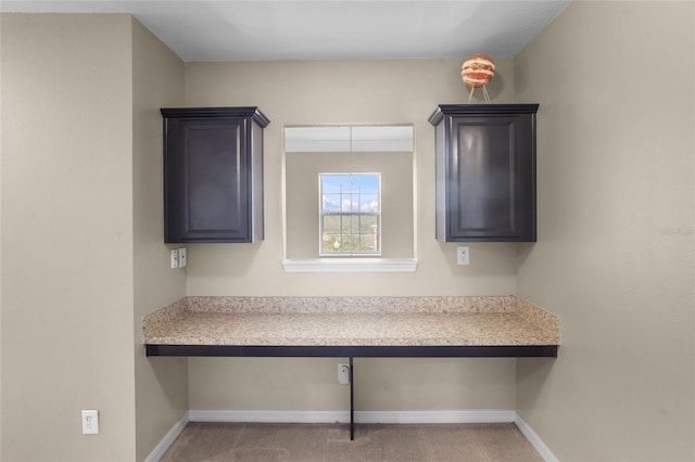 12353 Hammock Hill Dr, Clermont, FL 34711 - kitchen featuring built in desk, light countertops, and carpet