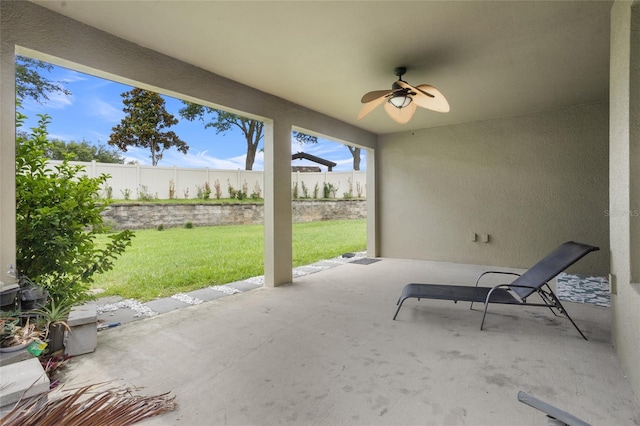 12353 Hammock Hill Dr, Clermont, FL 34711 - fenced backyard with ceiling fan and a patio