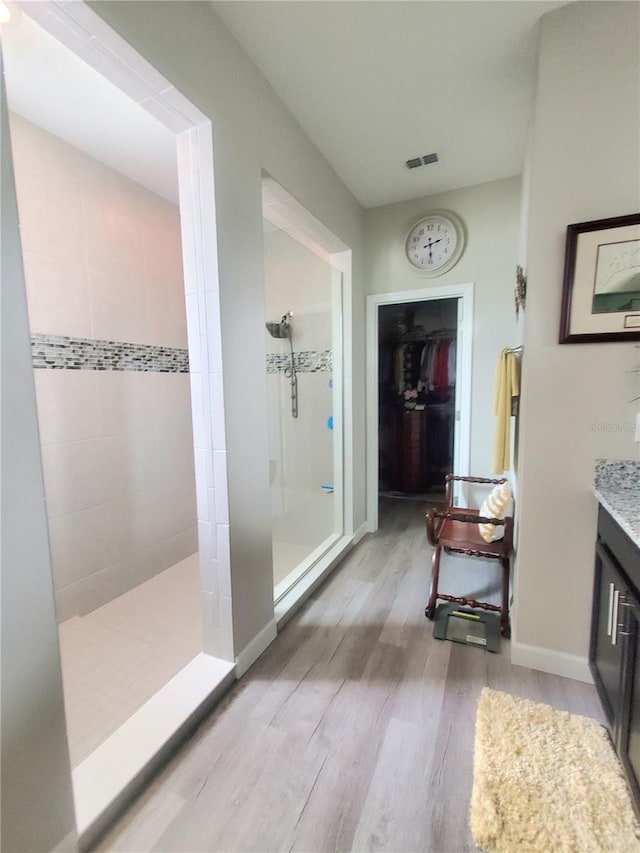 1456 Sourwood Dr, Ocoee, FL 34761 - bathroom featuring wood finished floors, walk in shower, vanity, and a spacious closet
