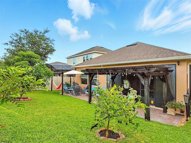 1456 Sourwood Dr, Ocoee, FL 34761 - rear view of house featuring a pergola, a patio, roof with shingles, and stucco siding