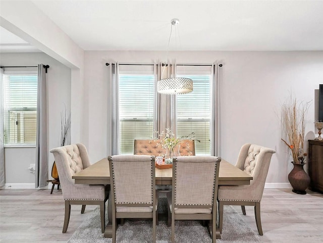 1456 Sourwood Dr, Ocoee, FL 34761 - dining area with light wood-style flooring and baseboards