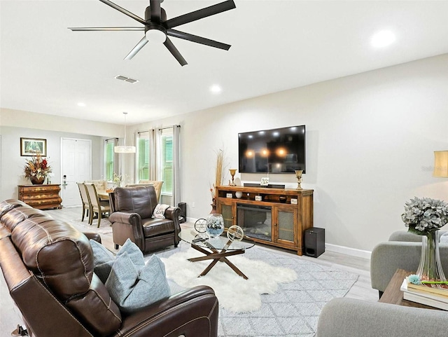 1456 Sourwood Dr, Ocoee, FL 34761 - living area featuring a ceiling fan, recessed lighting, wood finished floors, and a glass covered fireplace