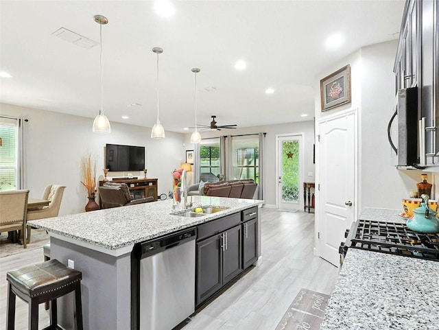 1456 Sourwood Dr, Ocoee, FL 34761 - kitchen featuring appliances with stainless steel finishes, open floor plan, plenty of natural light, a ceiling fan, and recessed lighting