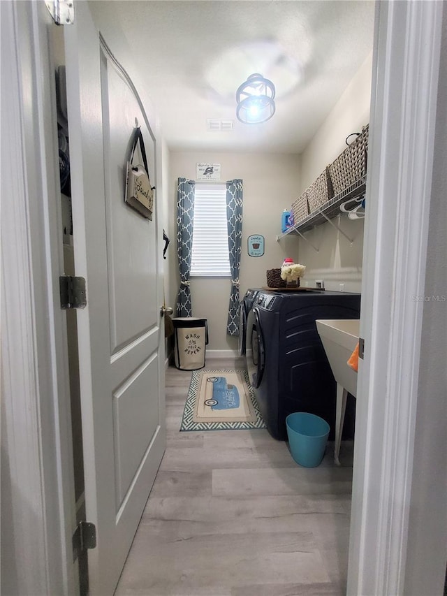 1456 Sourwood Dr, Ocoee, FL 34761 - washroom with independent washer and dryer and light wood finished floors