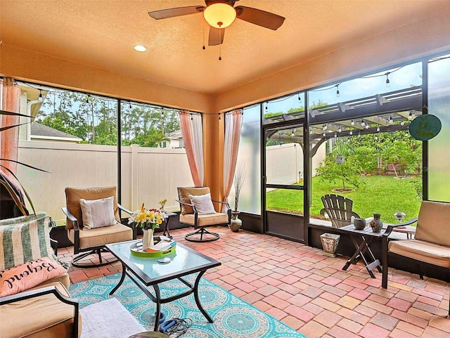 1456 Sourwood Dr, Ocoee, FL 34761 - sunroom featuring an outdoor hangout area, a ceiling fan, a textured ceiling, and plenty of natural light