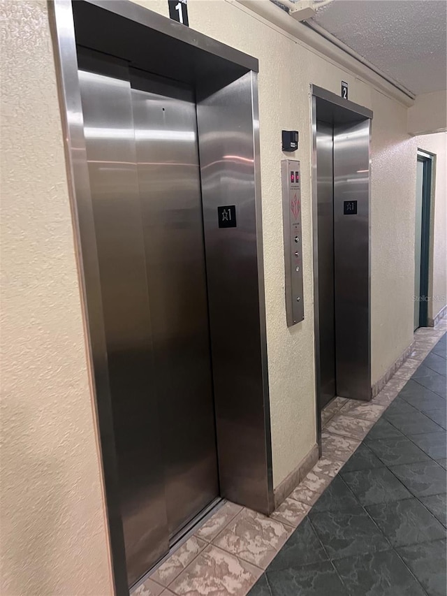 6831 SW 147th Ave Unit 3H, Miami, FL 33193 - elevator featuring a textured wall and a textured ceiling