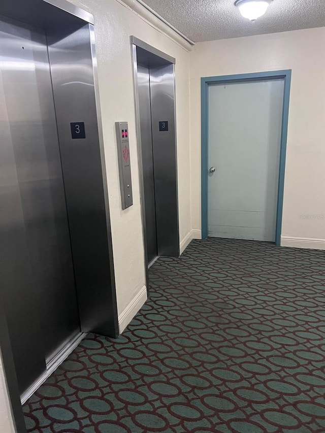 6831 SW 147th Ave Unit 3H, Miami, FL 33193 - hall featuring elevator, dark colored carpet, and a textured ceiling