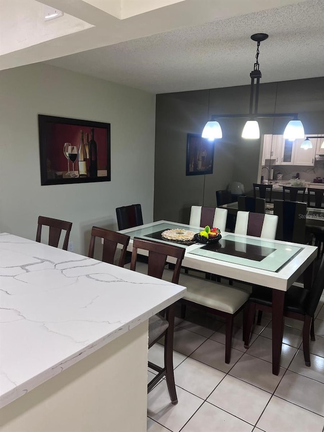 6831 SW 147th Ave Unit 3H, Miami, FL 33193 - dining area featuring light tile patterned floors and a textured ceiling