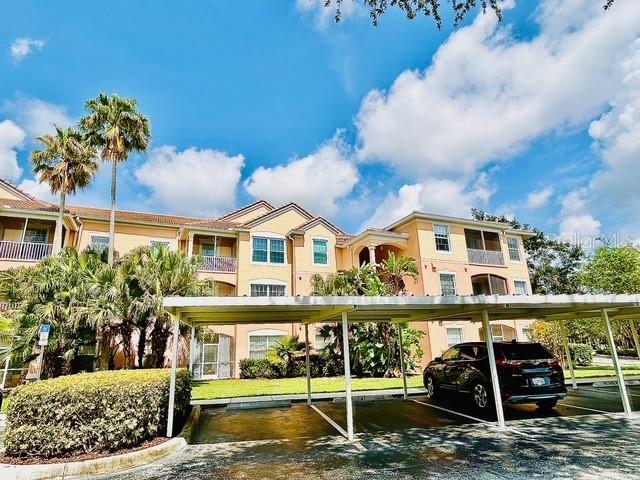 13500 Turtle Marsh Loop Unit 17, Orlando, FL 32837 - view of building exterior with covered parking