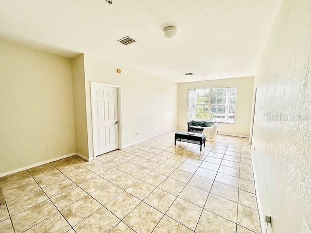 13500 Turtle Marsh Loop Unit 17, Orlando, FL 32837 - empty room with light tile patterned floors