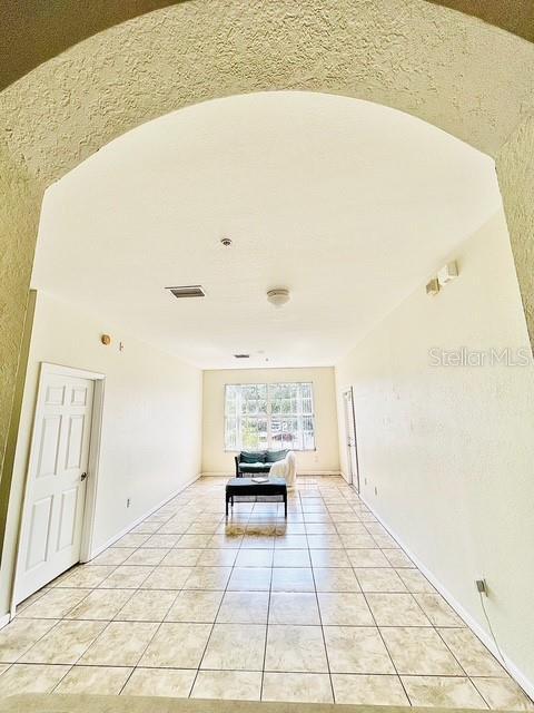 13500 Turtle Marsh Loop Unit 17, Orlando, FL 32837 - empty room with light tile patterned floors and baseboards