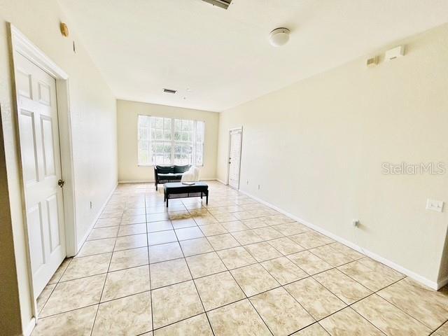 13500 Turtle Marsh Loop Unit 17, Orlando, FL 32837 - dining room featuring light tile patterned floors and baseboards