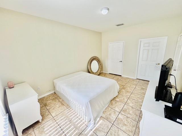 13500 Turtle Marsh Loop Unit 17, Orlando, FL 32837 - bedroom featuring light tile patterned floors and baseboards