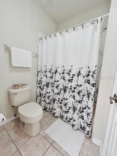 13500 Turtle Marsh Loop Unit 17, Orlando, FL 32837 - bathroom featuring tile patterned flooring and curtained shower
