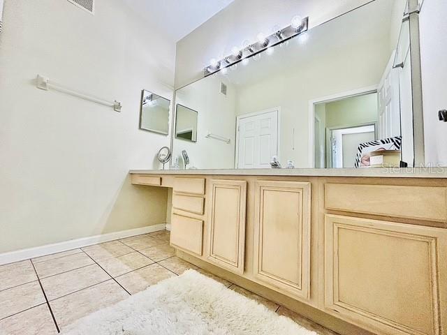 13500 Turtle Marsh Loop Unit 17, Orlando, FL 32837 - bathroom featuring tile patterned flooring and vanity