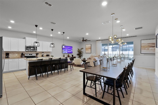 2131 Lelani Cir, Davenport, FL 33897 - dining room featuring recessed lighting, a ceiling fan, light tile patterned flooring, and a wainscoted wall