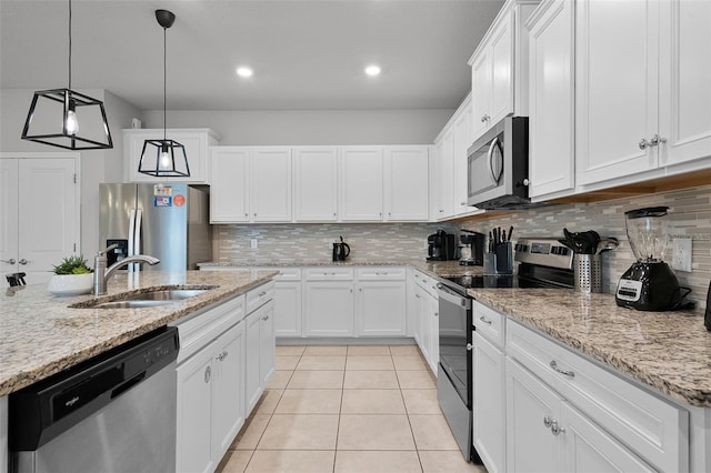 2131 Lelani Cir, Davenport, FL 33897 - kitchen with appliances with stainless steel finishes, light tile patterned floors, tasteful backsplash, white cabinetry, and recessed lighting