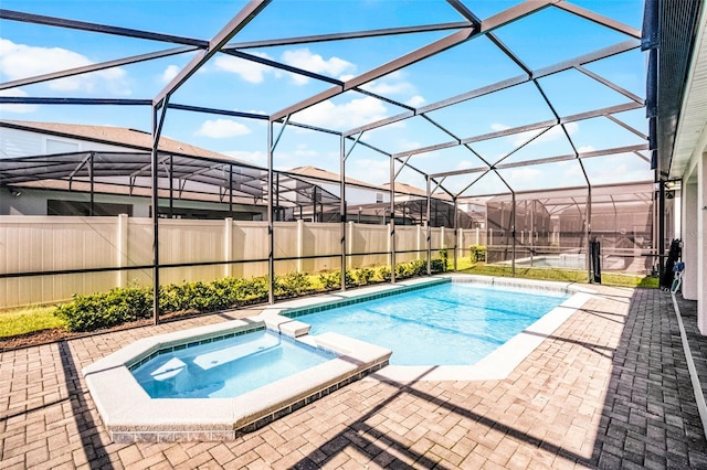 2131 Lelani Cir, Davenport, FL 33897 - view of swimming pool featuring a pool with connected hot tub, a patio, a fenced backyard, and glass enclosure