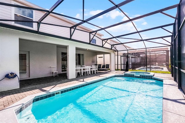 2131 Lelani Cir, Davenport, FL 33897 - view of pool with a patio area, a pool with connected hot tub, glass enclosure, and outdoor dining space