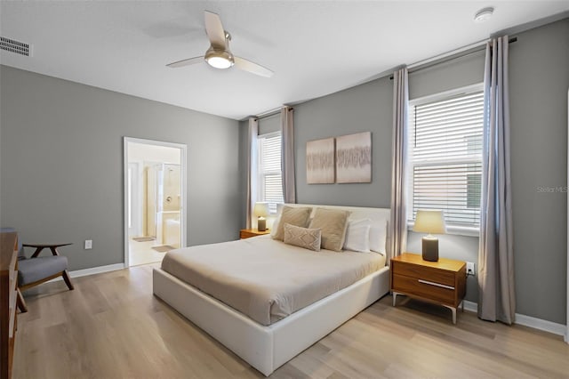 2131 Lelani Cir, Davenport, FL 33897 - bedroom featuring light wood-type flooring, ceiling fan, and connected bathroom
