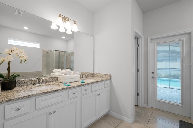 2131 Lelani Cir, Davenport, FL 33897 - bathroom featuring double vanity, a shower stall, tile patterned flooring, and a chandelier