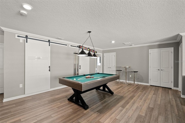 2131 Lelani Cir, Davenport, FL 33897 - recreation room with a barn door, light wood-style floors, ornamental molding, billiards, and a textured ceiling