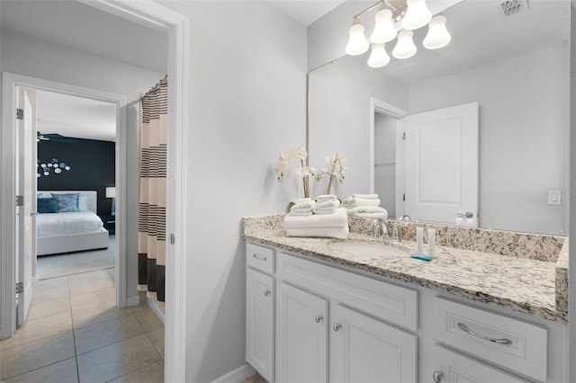 2131 Lelani Cir, Davenport, FL 33897 - ensuite bathroom featuring vanity, a chandelier, and tile patterned flooring
