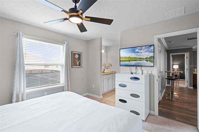2131 Lelani Cir, Davenport, FL 33897 - bedroom with a textured ceiling, connected bathroom, ceiling fan, and crown molding