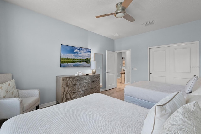 2131 Lelani Cir, Davenport, FL 33897 - bedroom with light wood finished floors, a closet, and ceiling fan