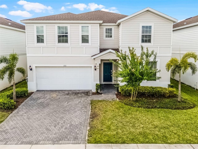 2131 Lelani Cir, Davenport, FL 33897 - view of front of property with decorative driveway, roof with shingles, a garage, and stucco siding