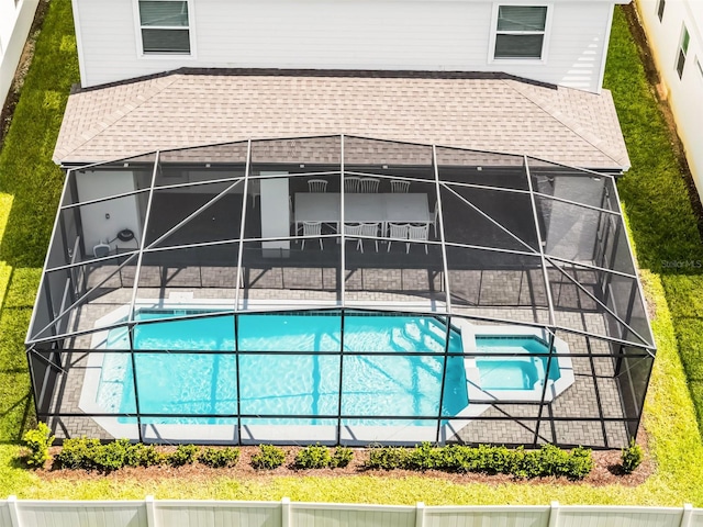 2131 Lelani Cir, Davenport, FL 33897 - swimming pool featuring a patio, glass enclosure, a fenced backyard, and a hot tub