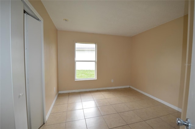 1207 Atlantic Ct, Kissimmee, FL 34759 - unfurnished bedroom featuring light tile patterned floors and a closet