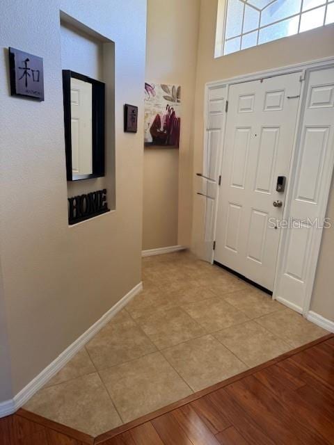 5435 Bryce Canyon Dr, Kissimmee, FL 34758 - entryway with baseboards and light wood finished floors