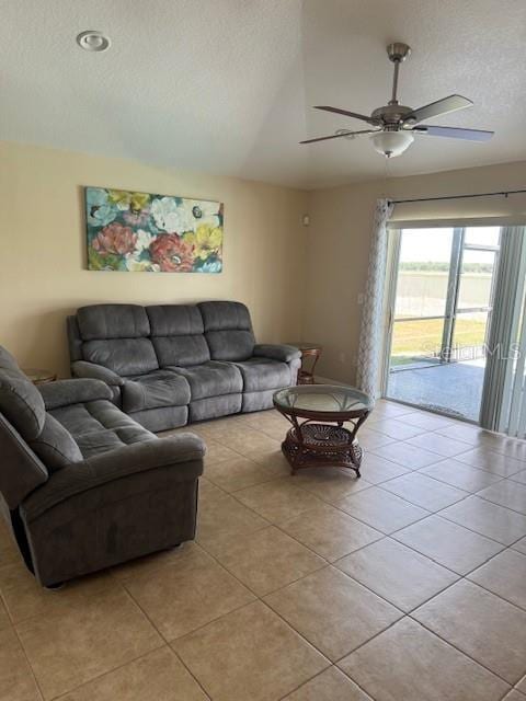 5435 Bryce Canyon Dr, Kissimmee, FL 34758 - living area with light tile patterned floors, a ceiling fan, a textured ceiling, and vaulted ceiling