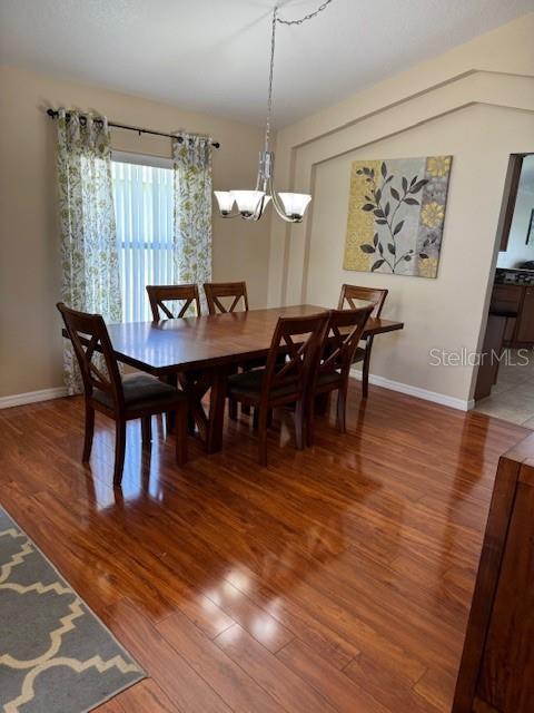 5435 Bryce Canyon Dr, Kissimmee, FL 34758 - dining area with wood finished floors and a chandelier