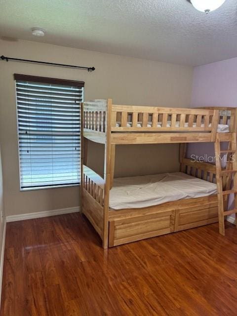 5435 Bryce Canyon Dr, Kissimmee, FL 34758 - bedroom featuring wood finished floors and a textured ceiling