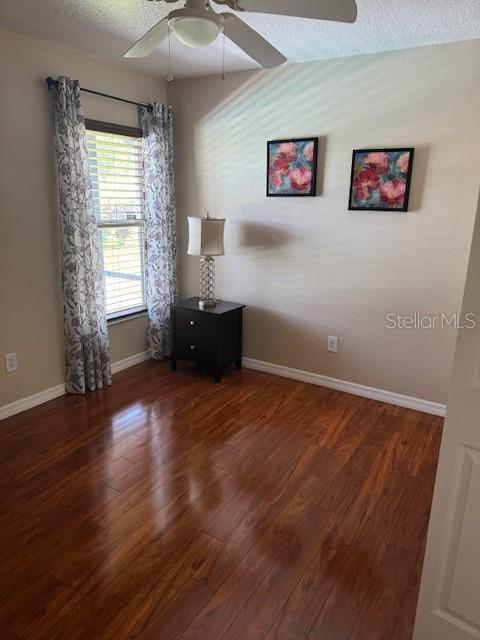 5435 Bryce Canyon Dr, Kissimmee, FL 34758 - spare room featuring ceiling fan, wood finished floors, and a textured ceiling