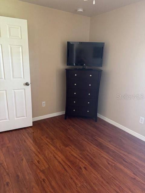 5435 Bryce Canyon Dr, Kissimmee, FL 34758 - unfurnished bedroom with dark wood-style floors and baseboards