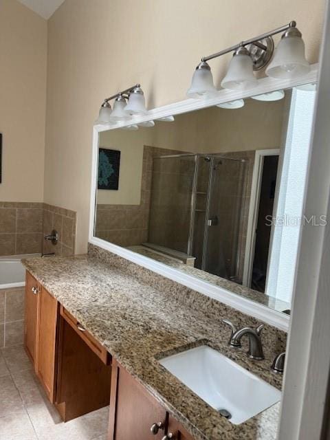 5435 Bryce Canyon Dr, Kissimmee, FL 34758 - full bathroom featuring tile patterned flooring, vanity, a bath, and a stall shower