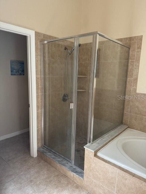 5435 Bryce Canyon Dr, Kissimmee, FL 34758 - full bath with a stall shower, a garden tub, and tile patterned floors