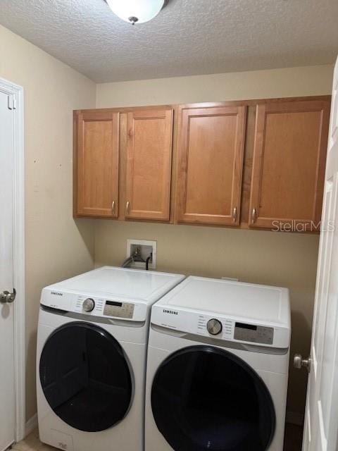 5435 Bryce Canyon Dr, Kissimmee, FL 34758 - laundry room with separate washer and dryer, cabinet space, and a textured ceiling